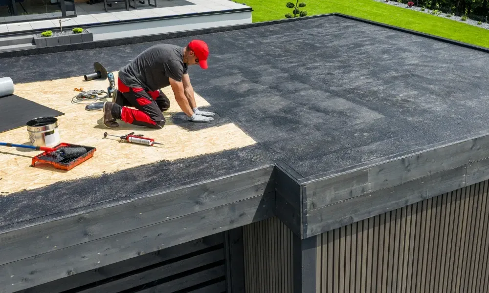 Hand lifting damaged shingle revealing gap at eave — what are signs of roof damage after a storm