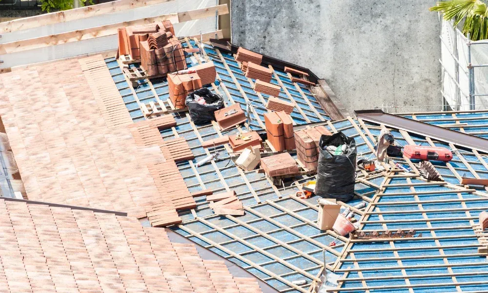Aerial of crew tearing off old shingles and re-decking a home — roofing contractor near me Palm Springs