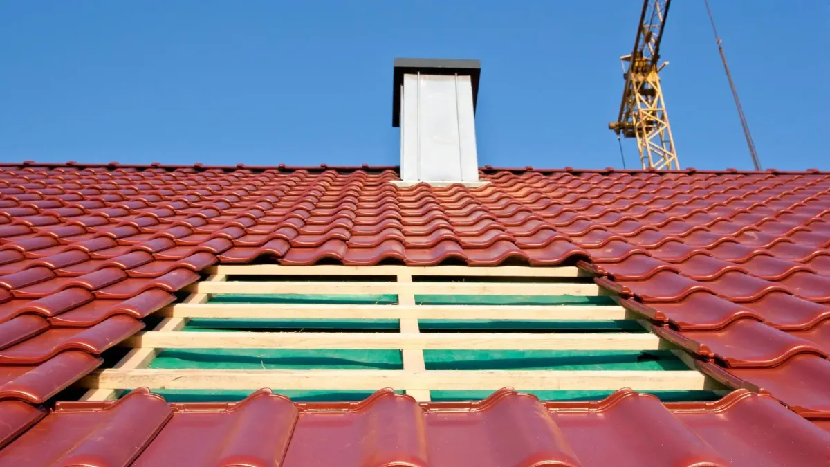 Yellowed and crazed acrylic dome being lifted off a 1970s roof — skylight re-flashing and resealing Rancho Mirage