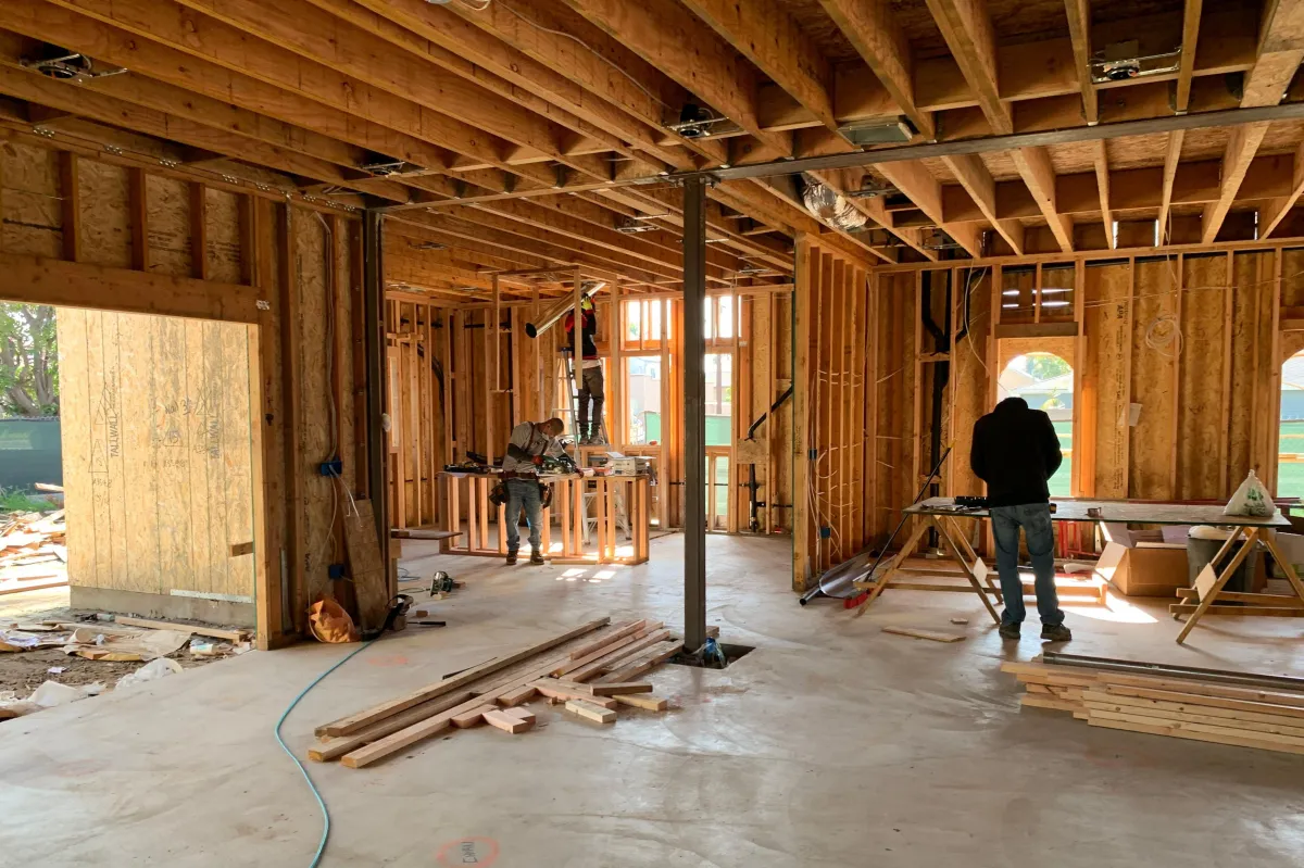 A group of builders working on the new construction of a house