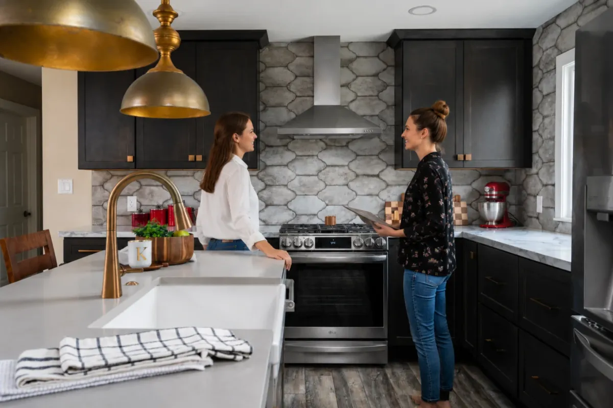 Designer speaking to client in a remodeled kitchen done by Delight Remodel