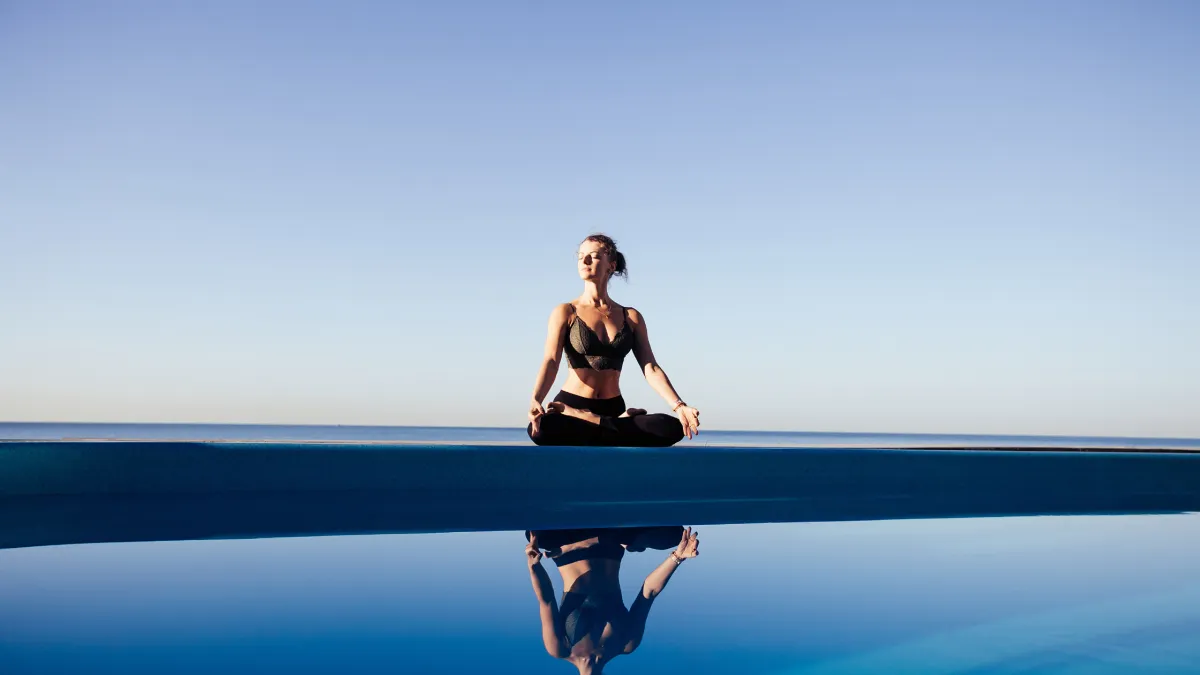 Person standing confidently in calm reflective setting