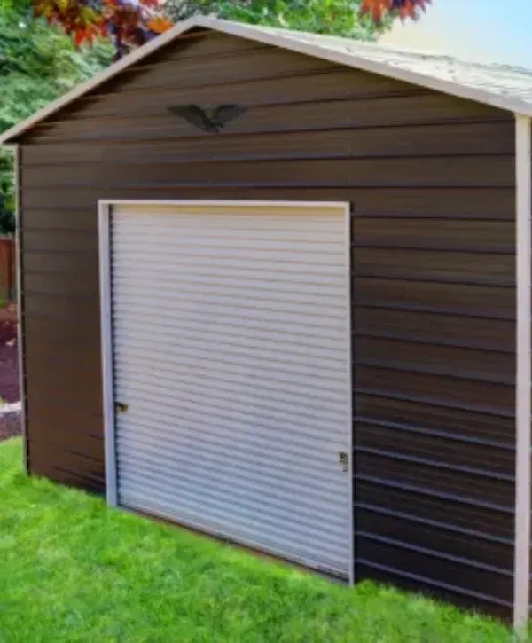 Brown metal garage with white roll-up door on green lawn