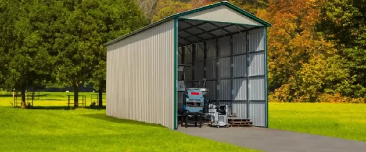 Tall metal shed with equipment storage in a rural green field