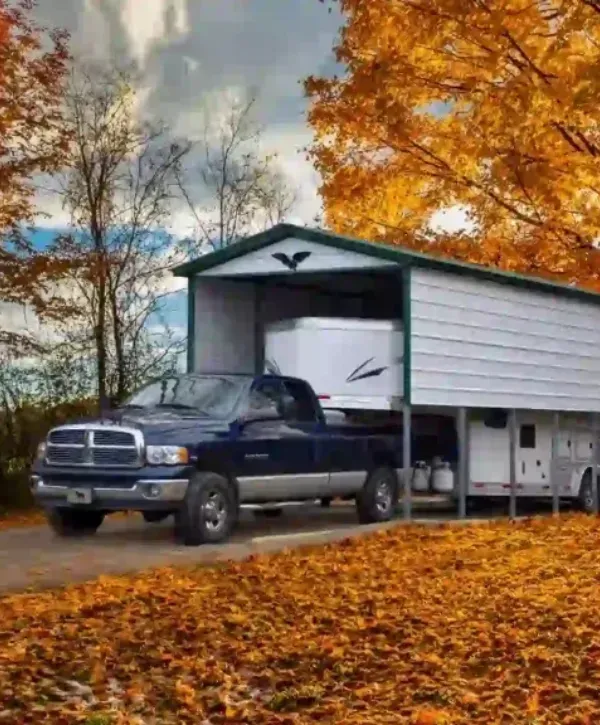 Metal RV cover protecting a truck and camper in autumn
