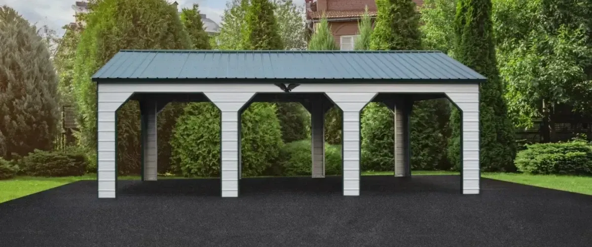 White and green three-car metal carport in a landscaped yard
