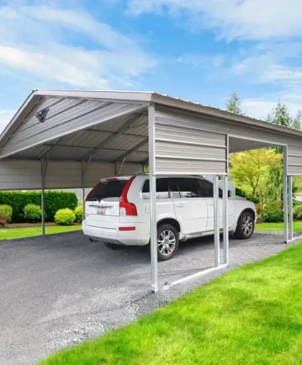Single-car metal carport shelter protecting a white SUV on a gravel driveway