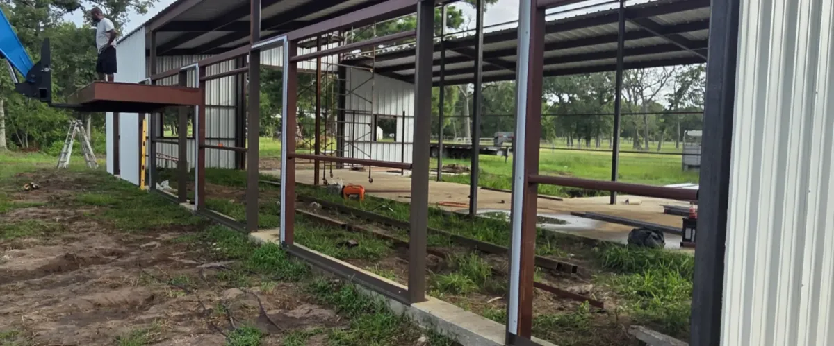 Steel frame building under construction on concrete slab