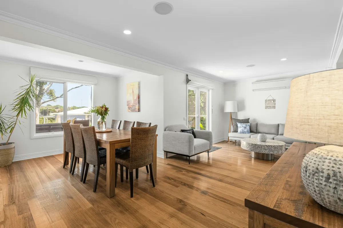 Modern finished basement room with hardwood flooring and large windows in St Albert