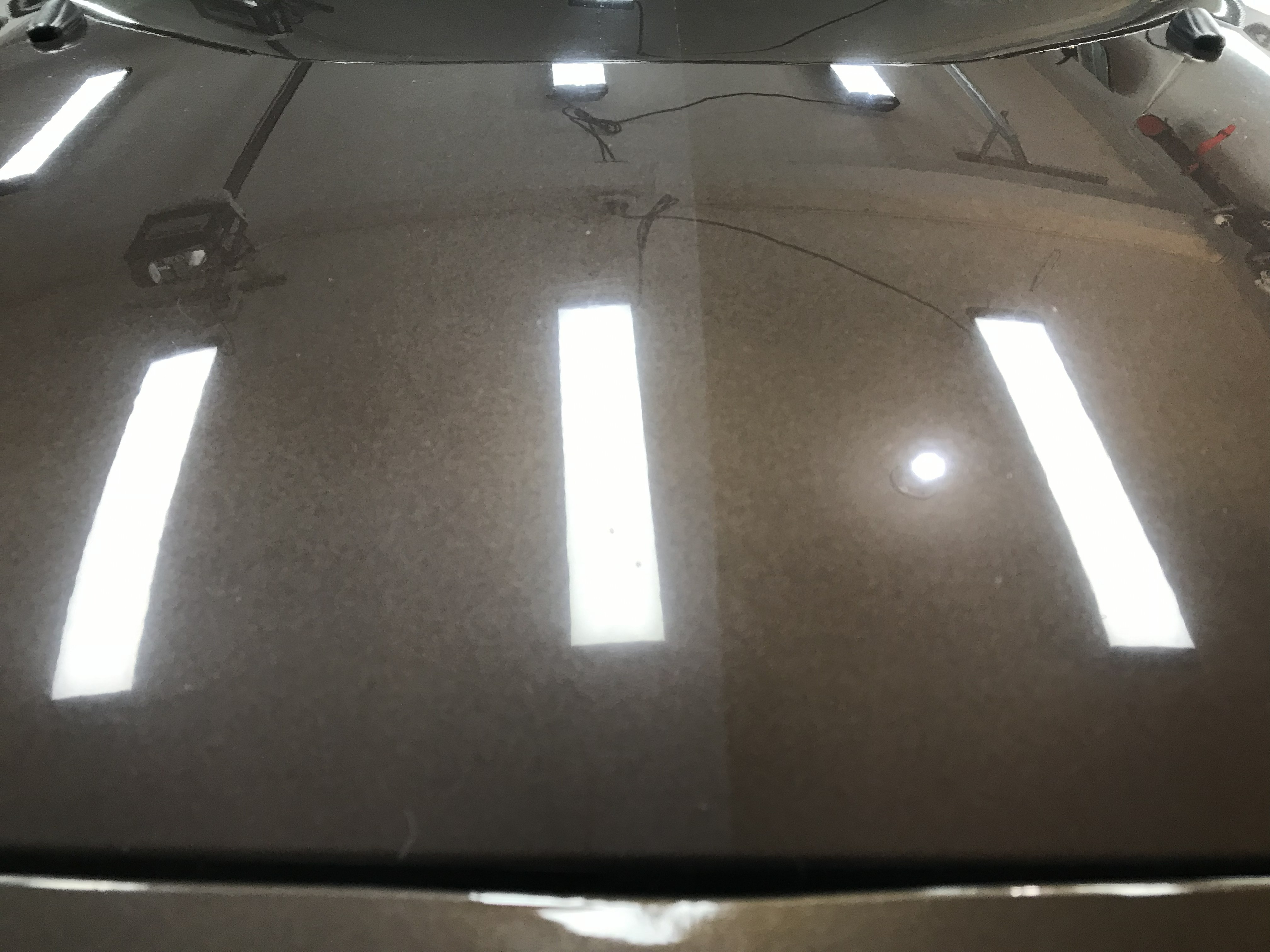 A car engine is visible inside its hood.