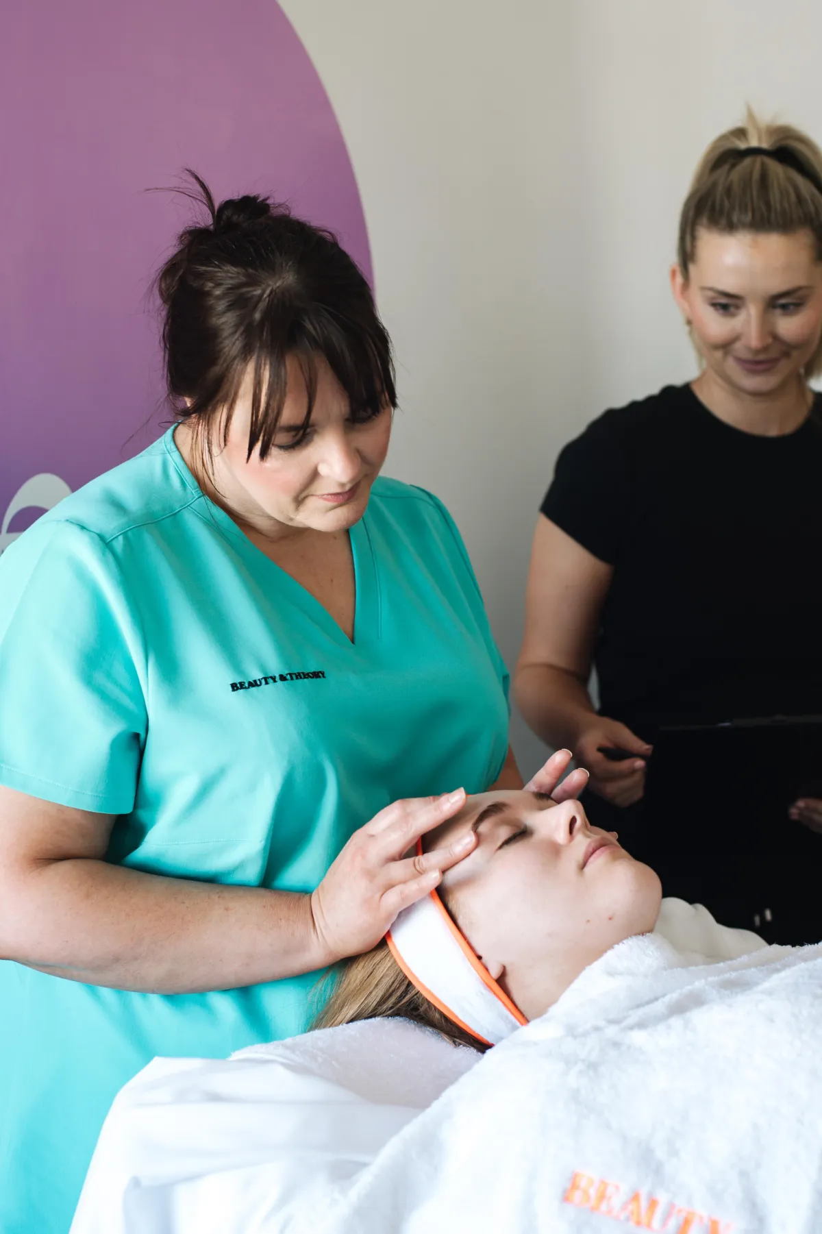 Tutor demonstrating a facial treatment