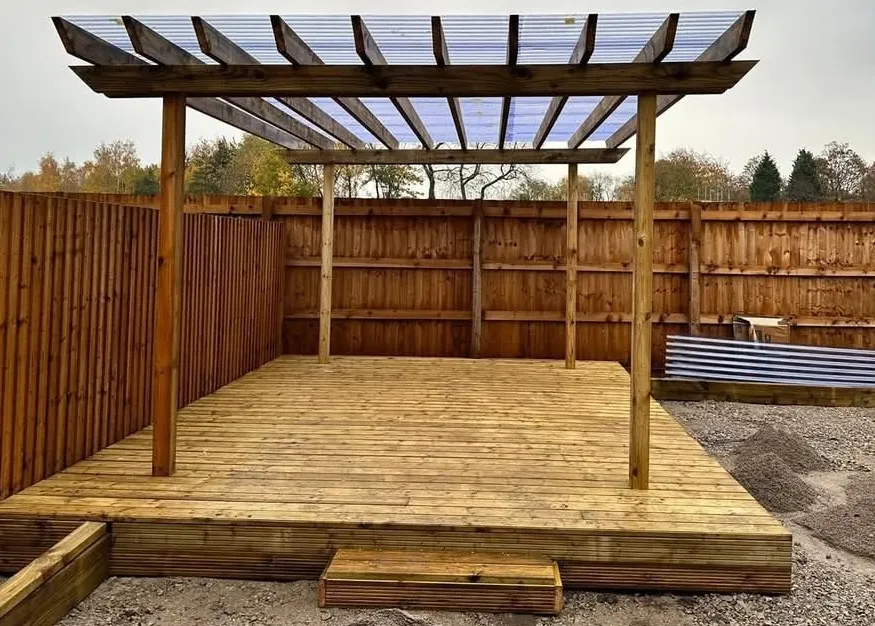 Raised timber deck with covered pergola in Wythenshawe, Manchester