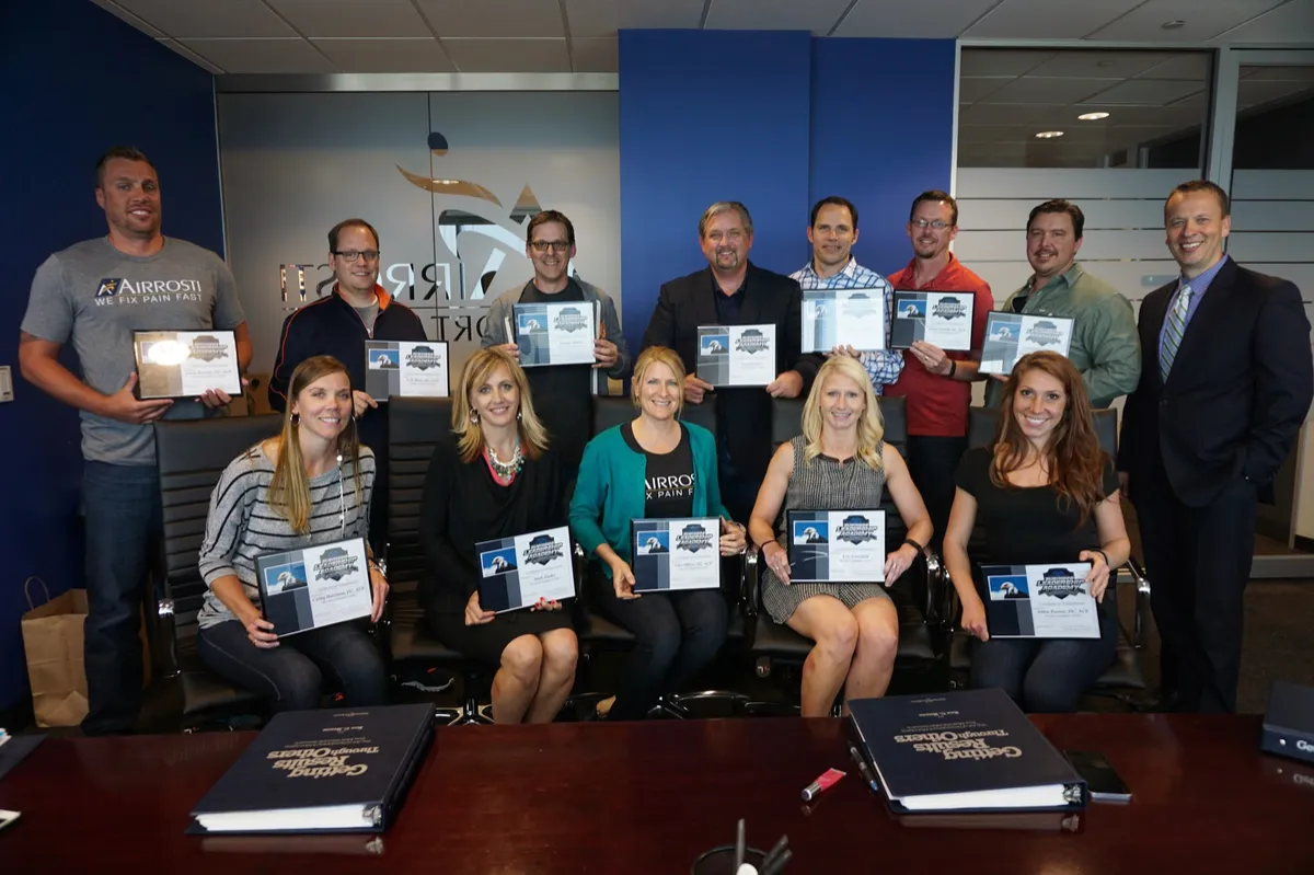 Getting Results Through Others graduates holding their Dynamic Leader certificates