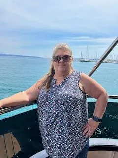 Ann Spire, founder of Aspire 4 Travel, smiling on a cruise deck