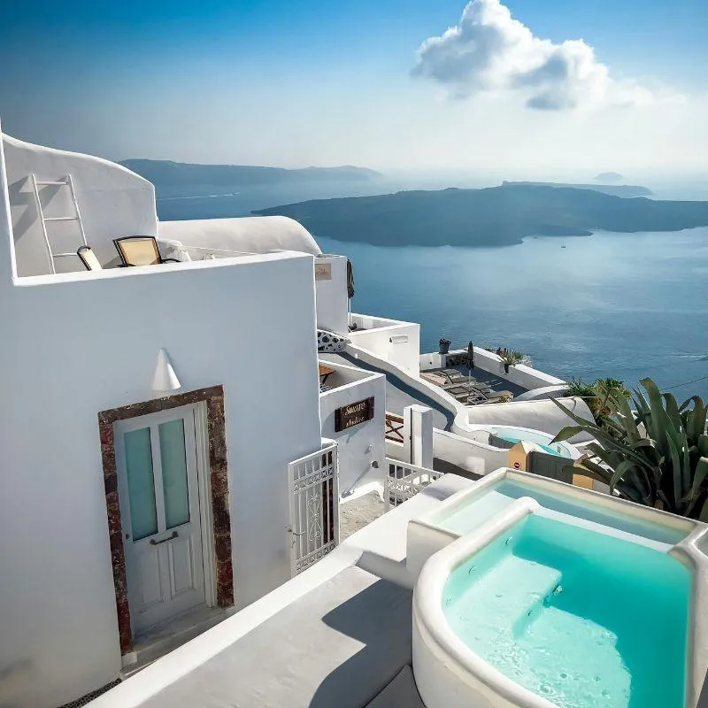 Santorini cliffside terrace with whitewashed buildings and sea view — part of Aspire 4 Travel’s 2025 group trip for adults in their 40s and 50s