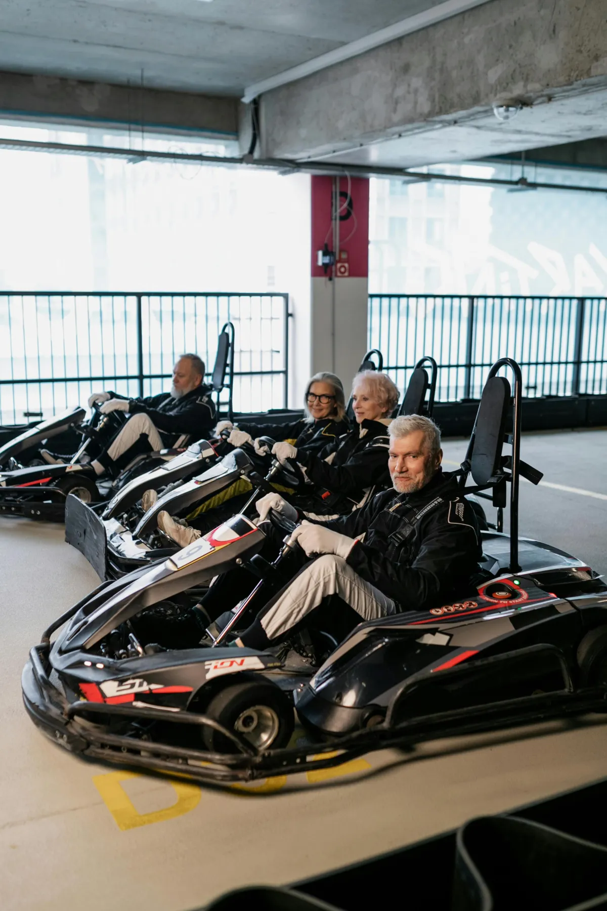 Adventurous adults 50+ enjoying a fun go-kart experience