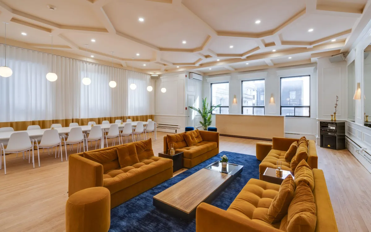 a bride and groom kiss in the rain under an umbrella