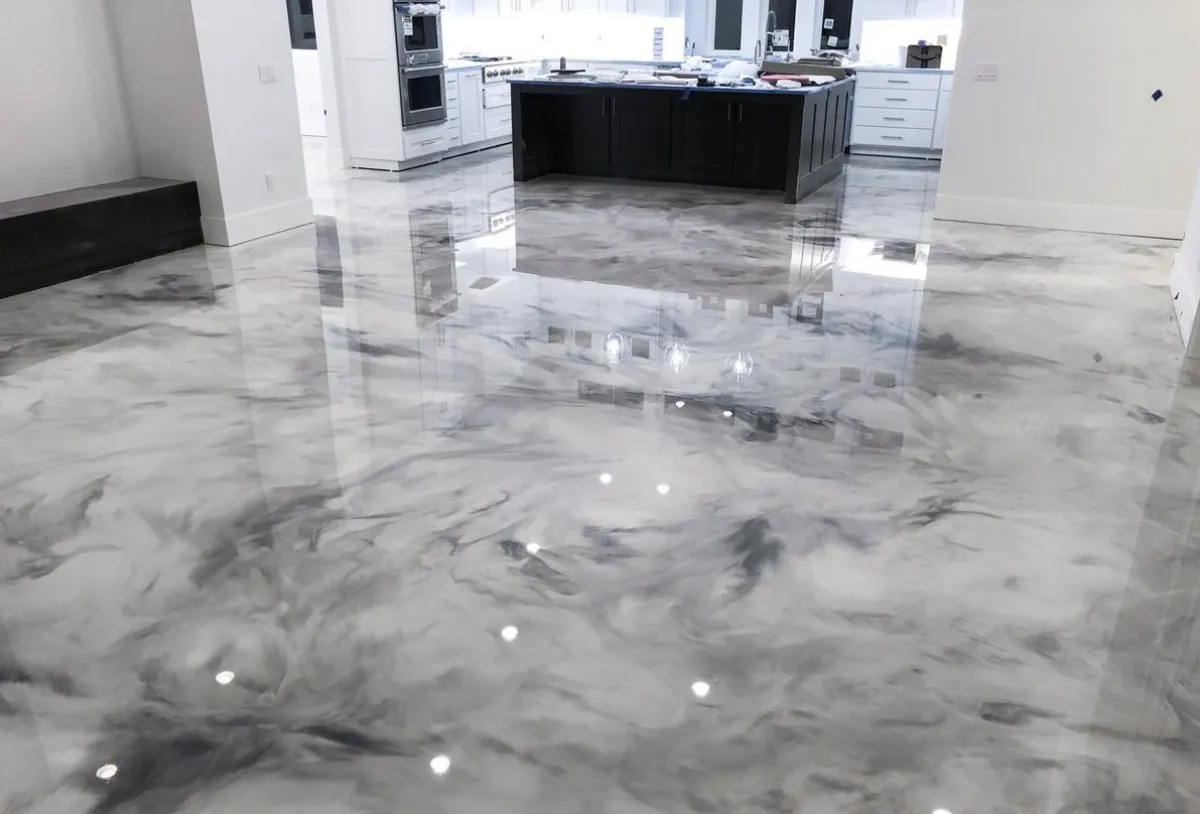 Metallic epoxy flooring service featuring a high-gloss, seamless concrete coating with custom metallic design