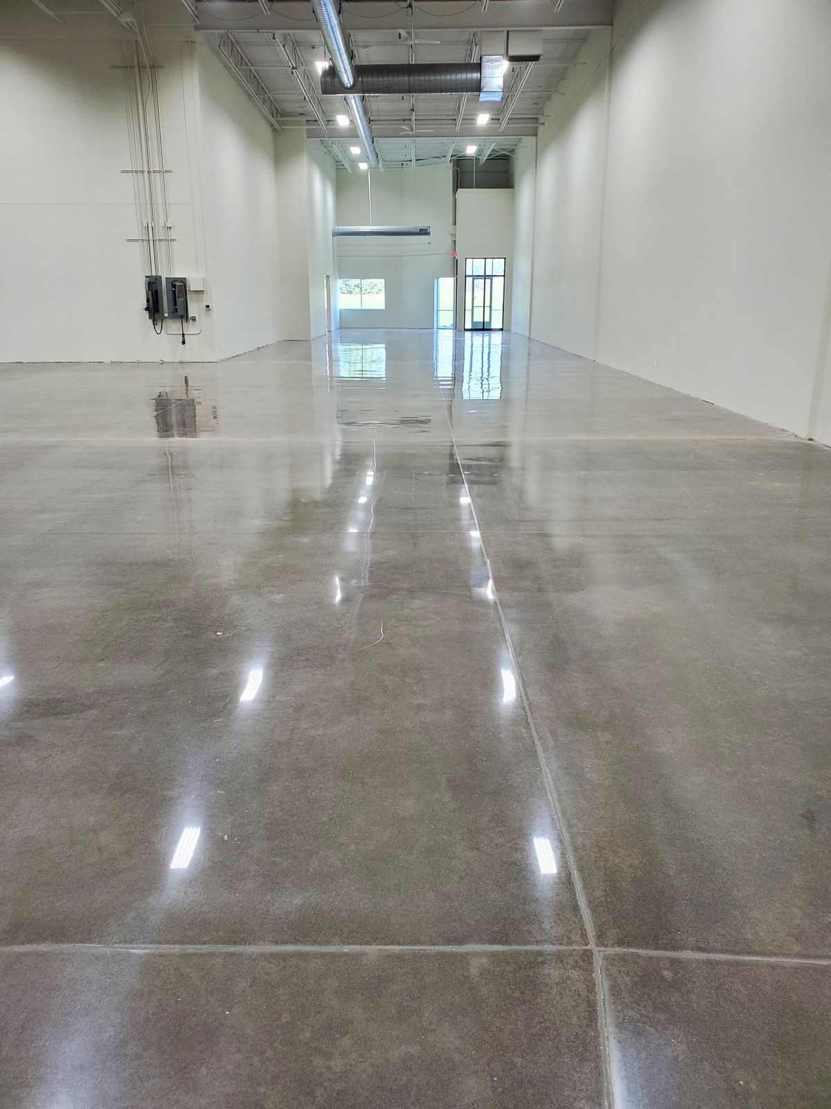 Polished concrete flooring service for industrial and commercial spaces featuring a durable, low-maintenance concrete finish