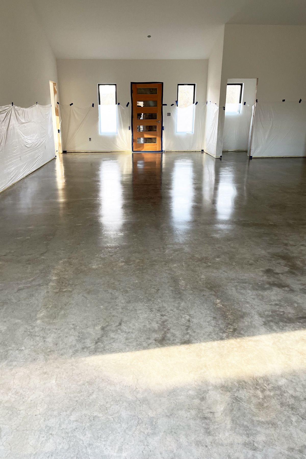 After photo of polished concrete flooring in a residential space with a clean, modern concrete finish