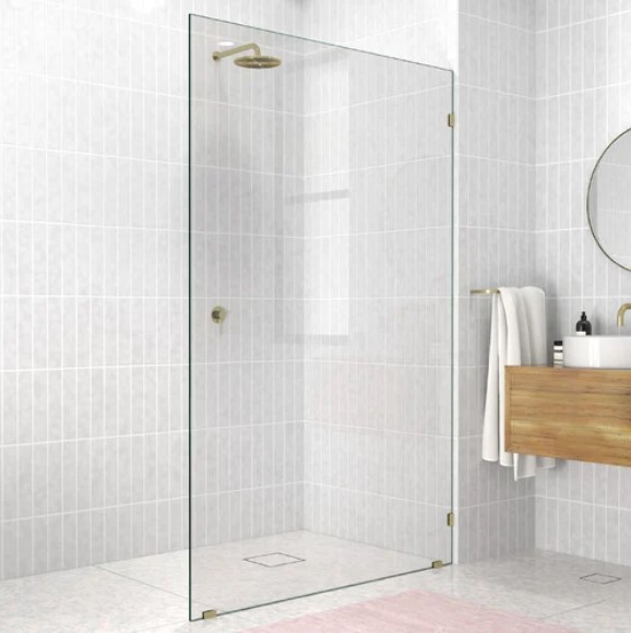 walk in shower with grey silver walled tiled and golden fixtures