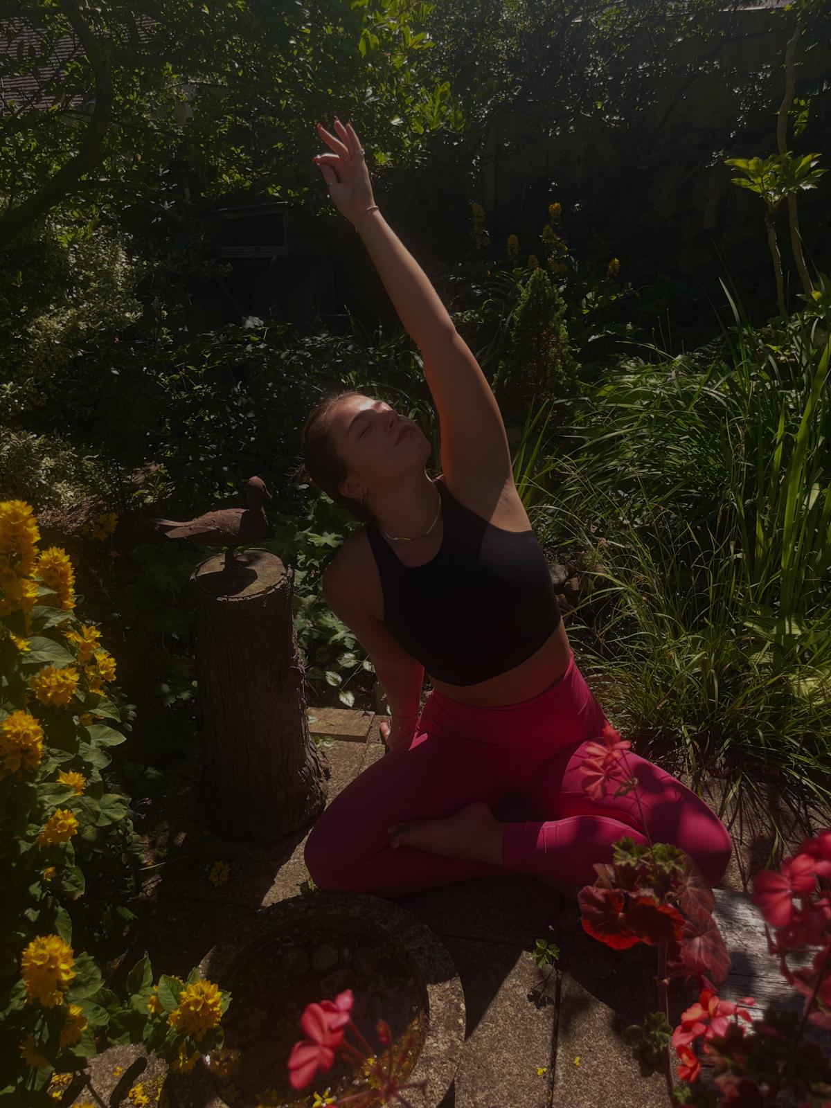 Woman practicing yoga on mat in park