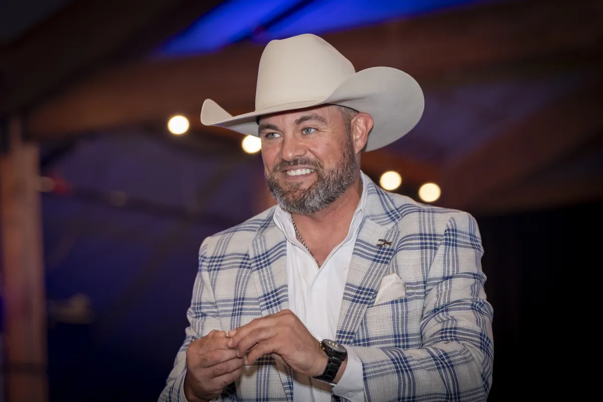 Ferron wearing a cowboy hat, smiling