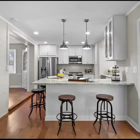 St. Louis kitchen remodel contractors installing custom white shaker cabinets and quartz countertops