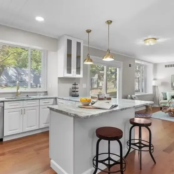 Luxury kitchen remodel near me with farmhouse sink, hardwood flooring, and pendant lighting