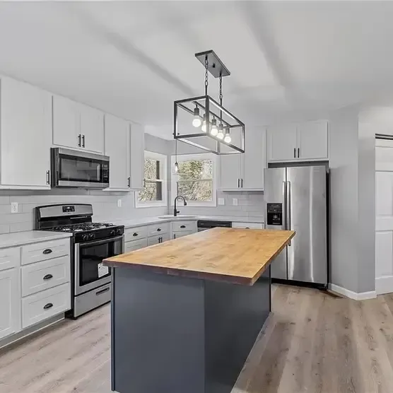 Modern kitchen renovation near St. Louis with gray subway tile backsplash and stainless steel appliances