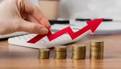 Hand holding red upward arrow with coins for growth in dental marketing