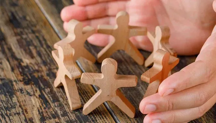 Developer coding on multiple screens for dental website design