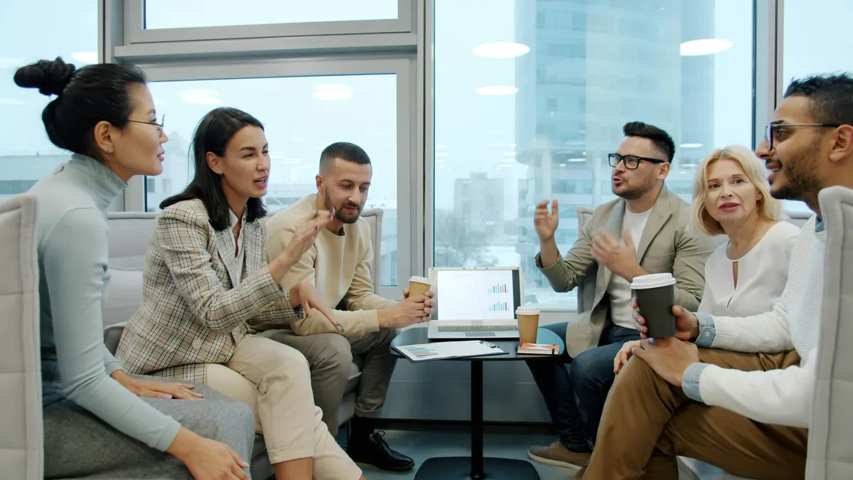Business professionals collaborating in a modern office, discussing strategy, client communication, and streamlined business processes.