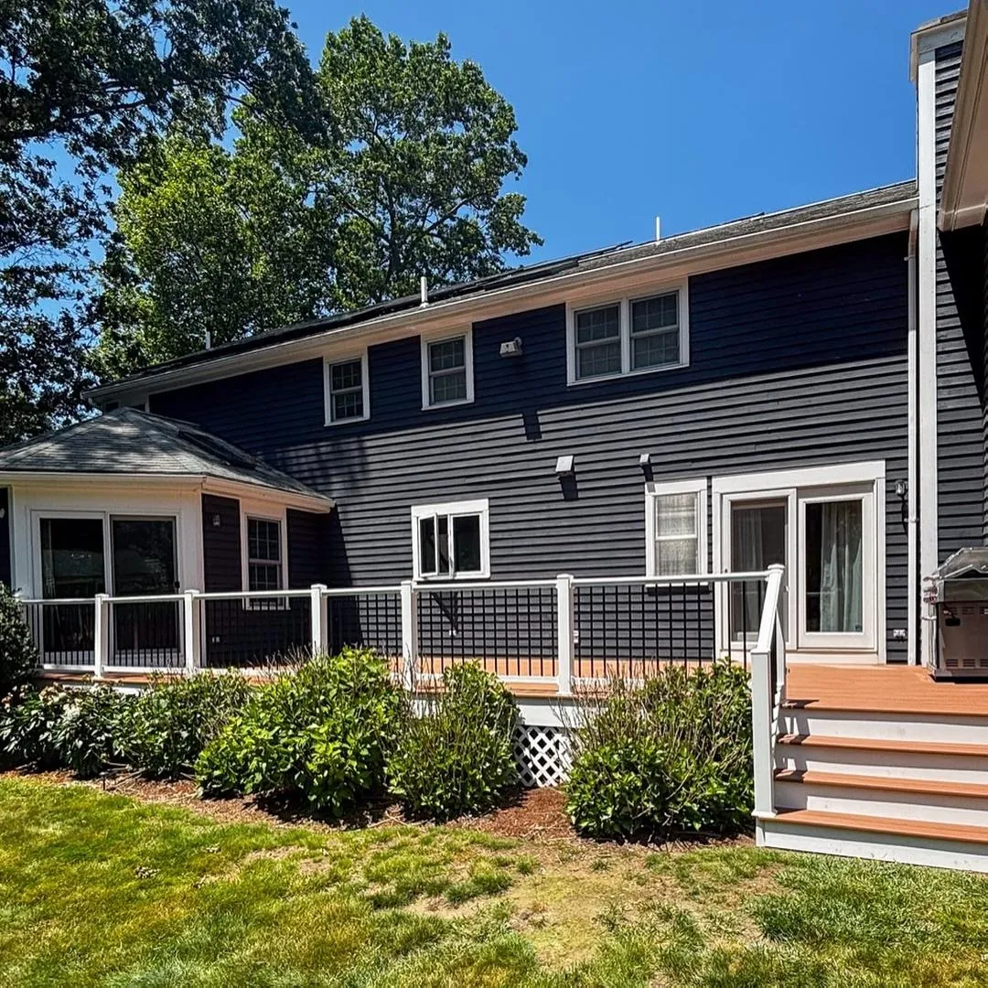 Historic home in Hingham featuring blue siding, double-hung windows, and a welcoming front entry with a porch, showcasing North Star-Bailey's exterior restoration services.