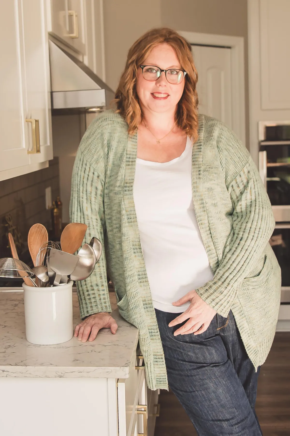 Image of Katie the owner of OWK in a kitchen with a set of towels