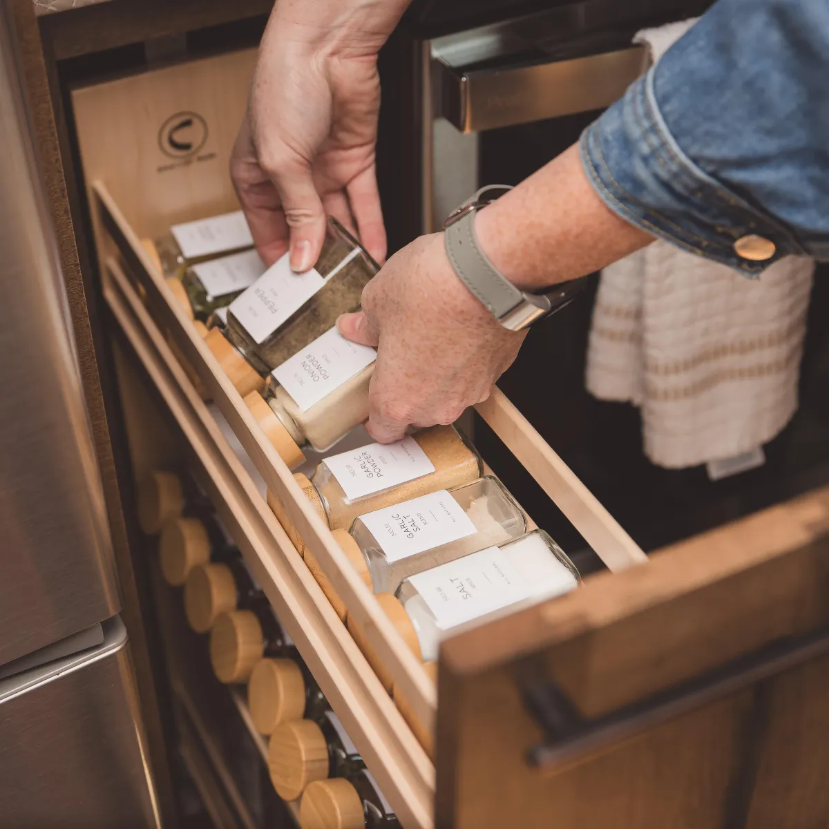 image of hands putting spice jar away