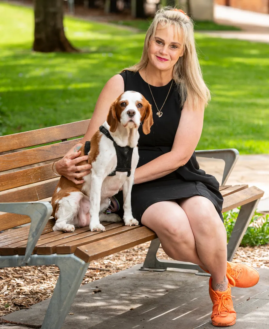 Julie McCracken alongside her dog, representing advocacy and ethical leadership in disability and aged care.