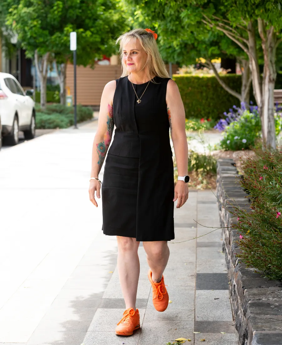 Julie McCracken walking with confidence, symbolizing advocacy and visionary leadership in care.