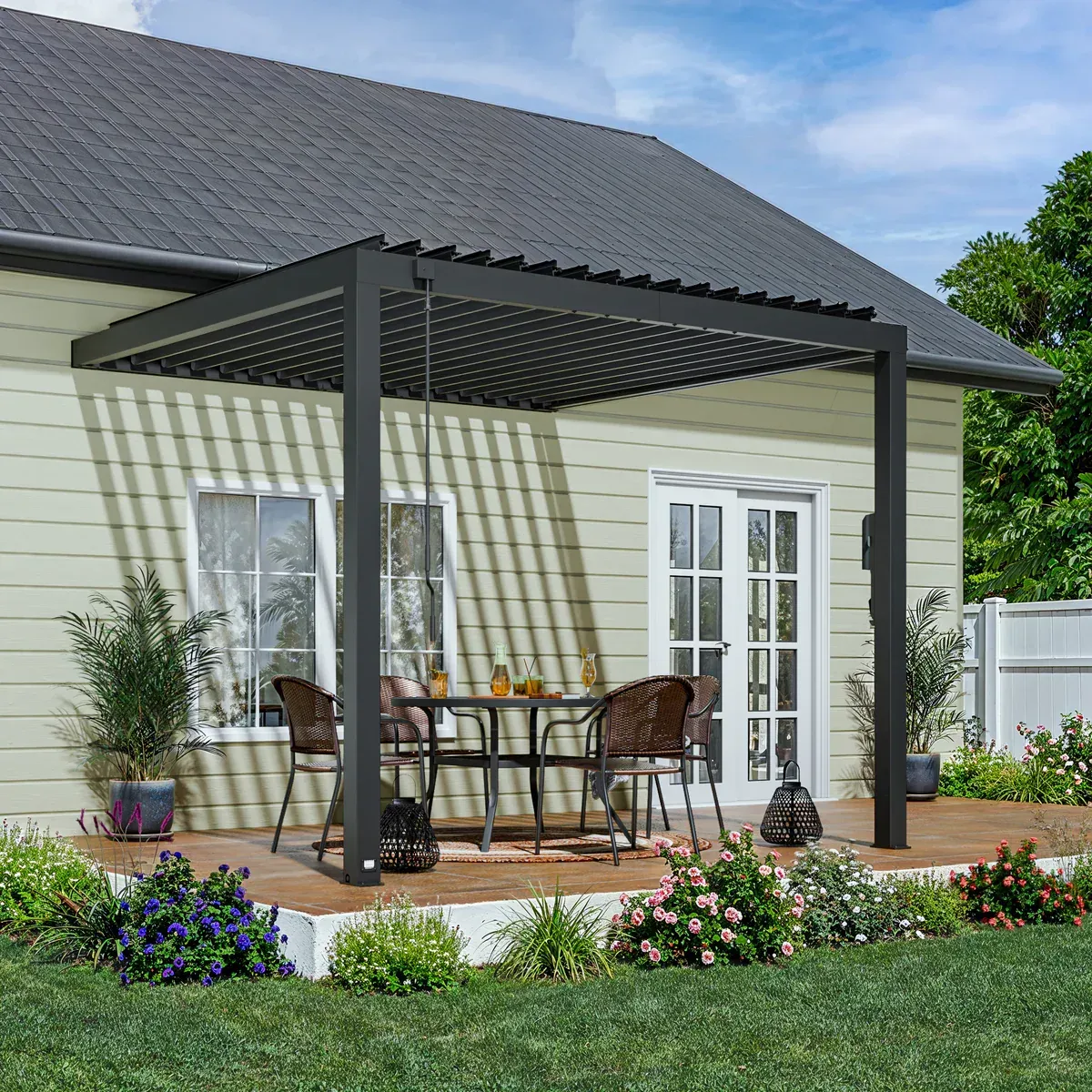 Wooden poolside pergola with dark roof and outdoor lounge furniture underneath.