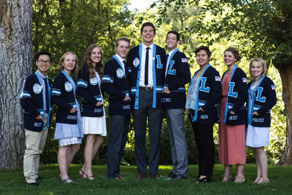 a woman sitting at a table with a sewing machine