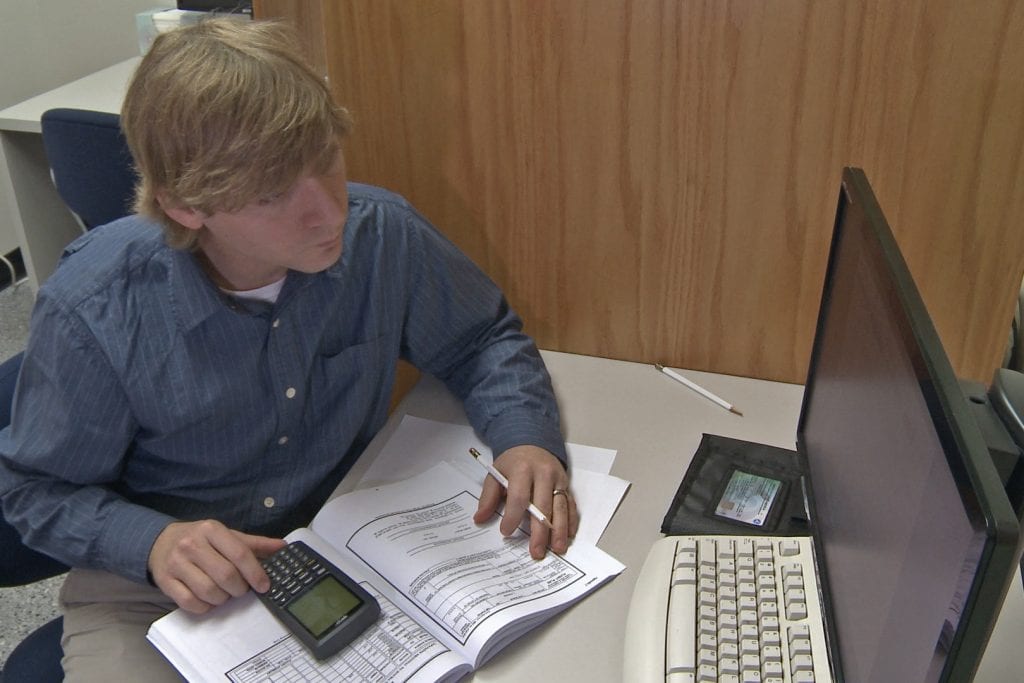 man taking instrument written exam