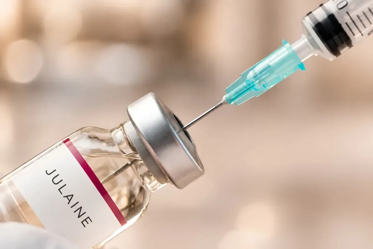 Close-up of a syringe drawing up Julaine PLLA injectable solution for skin rejuvenation