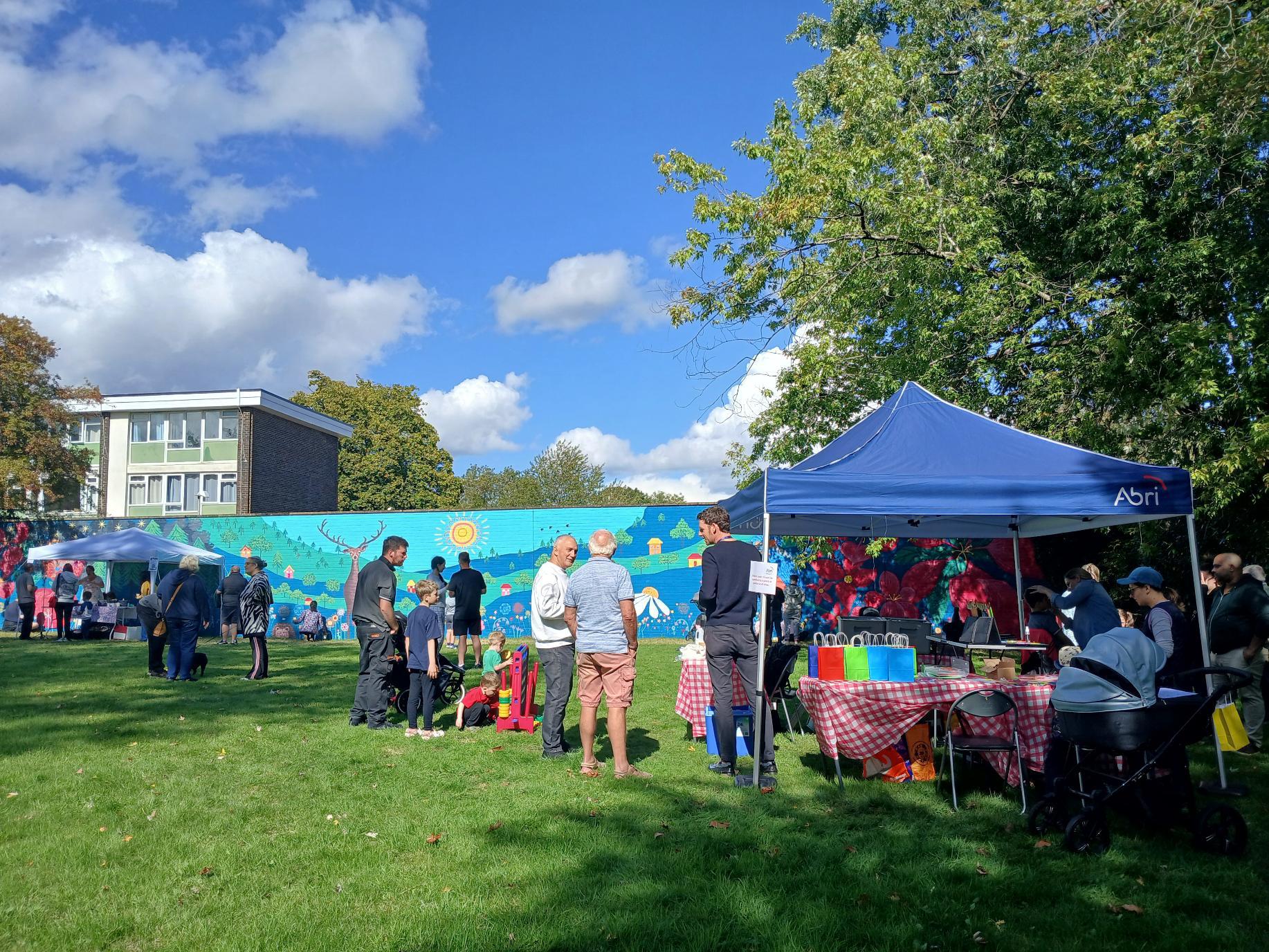 Residents gathering at the Wild & Wonder™ community mural celebration at Campion House, Bracknell, hosted by Janine Tonkin and Abri to celebrate the completion of the community mural project.