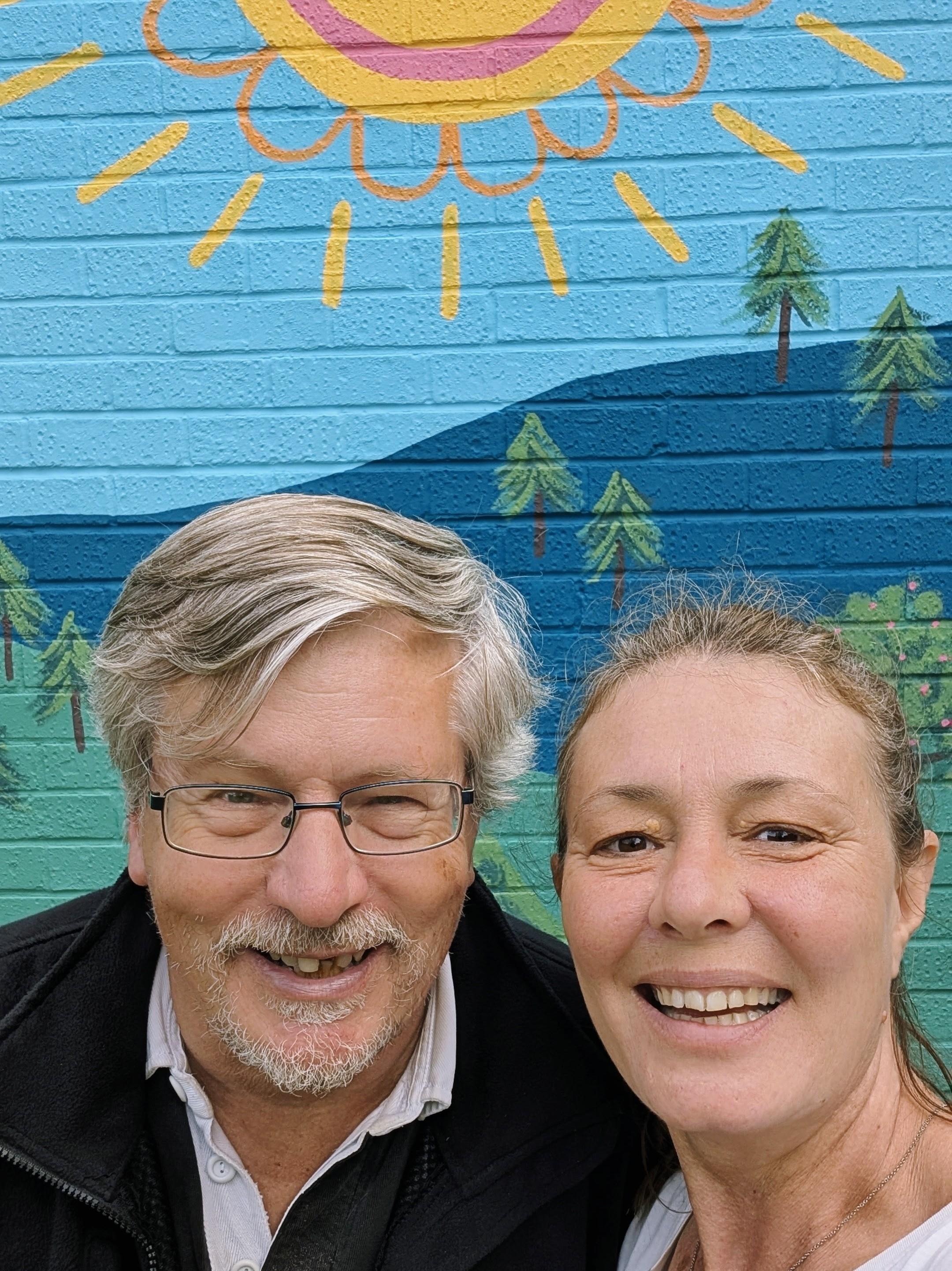 Neil Birkett with Janine Tonkin™ in front of the completed Wild & Wonder™ community mural at Campion House, Bracknell, celebrating the finished community artwork