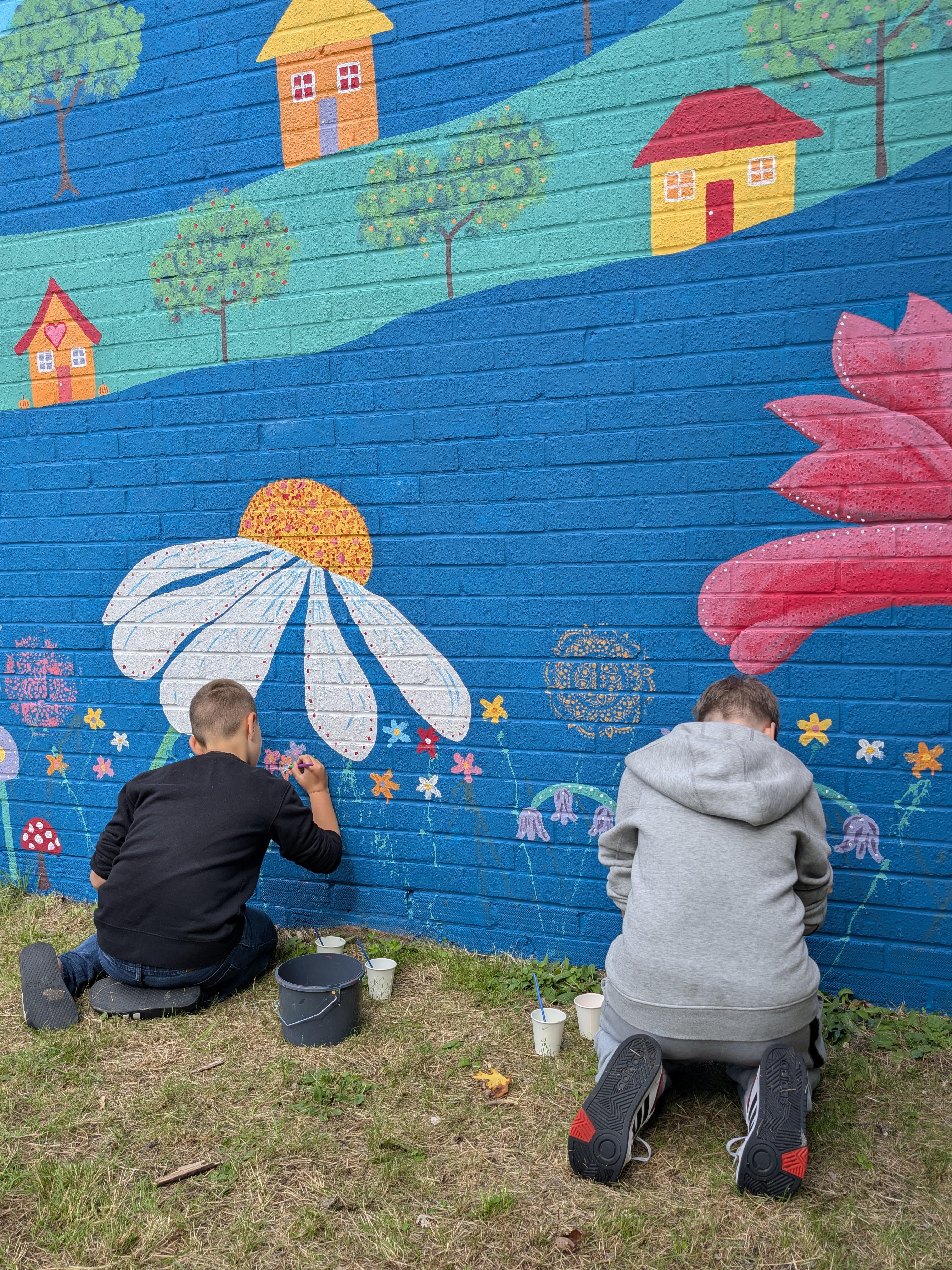 Families creating their own lasting contribution to the Wild & Wonder™ mural by Janine Tonkin™