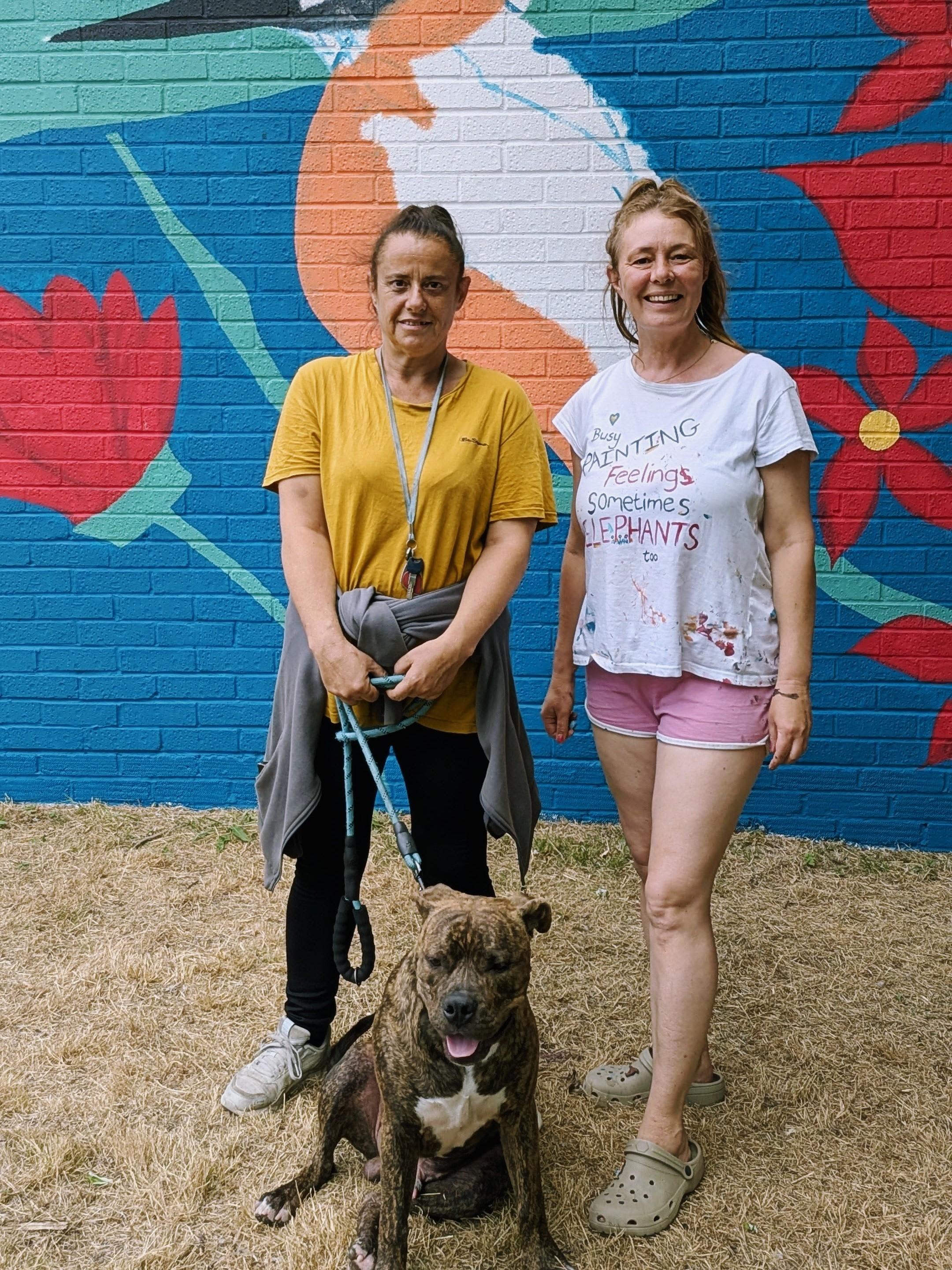 Residents and their dog visiting the completed Wild & Wonder™ community mural by Janine Tonkin™ at Campion House, celebrating community pride and local placemaking.