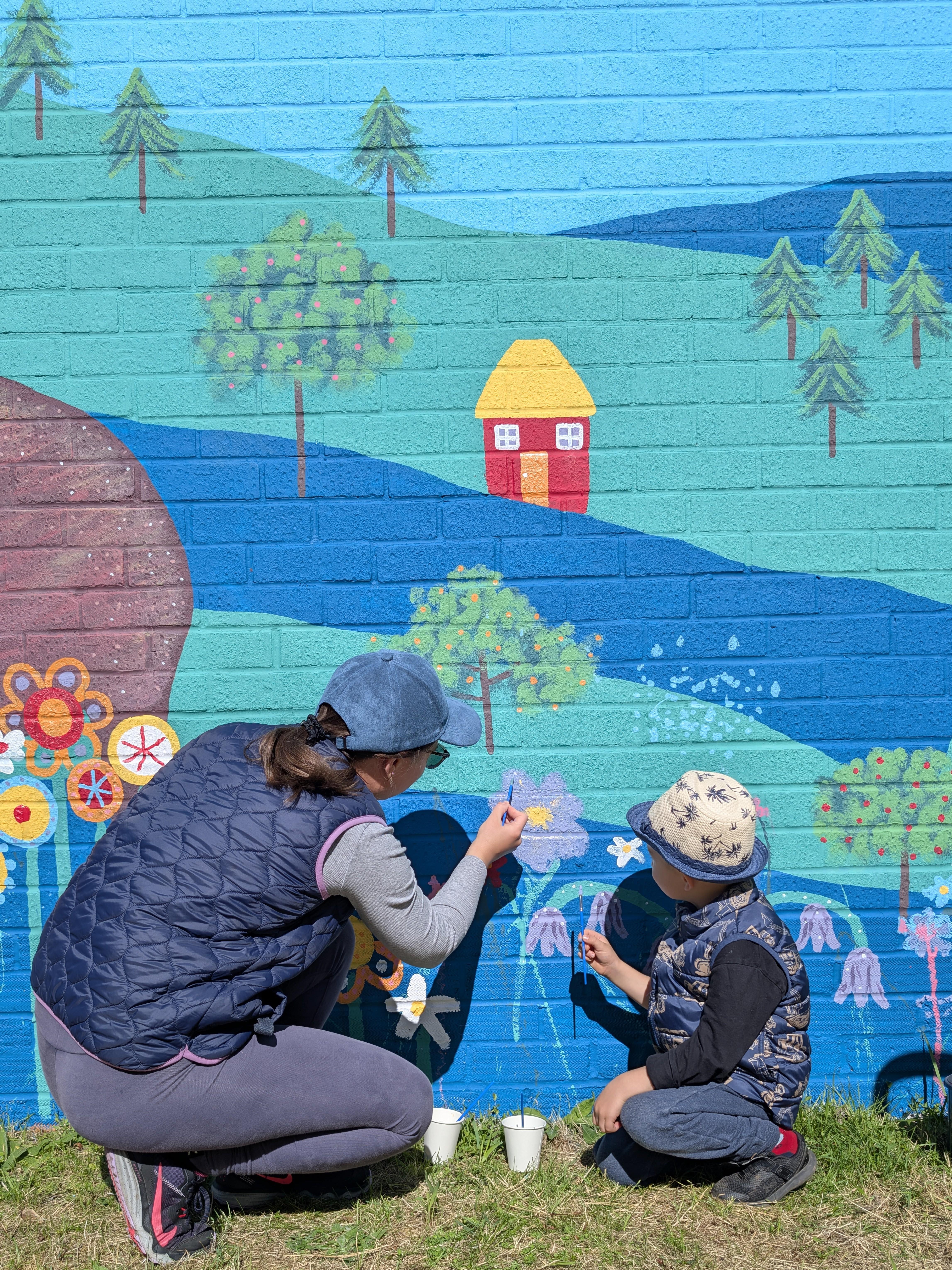 Families taking part in the Wild & Wonder™ interactive community painting experience designed by Janine Tonkin™