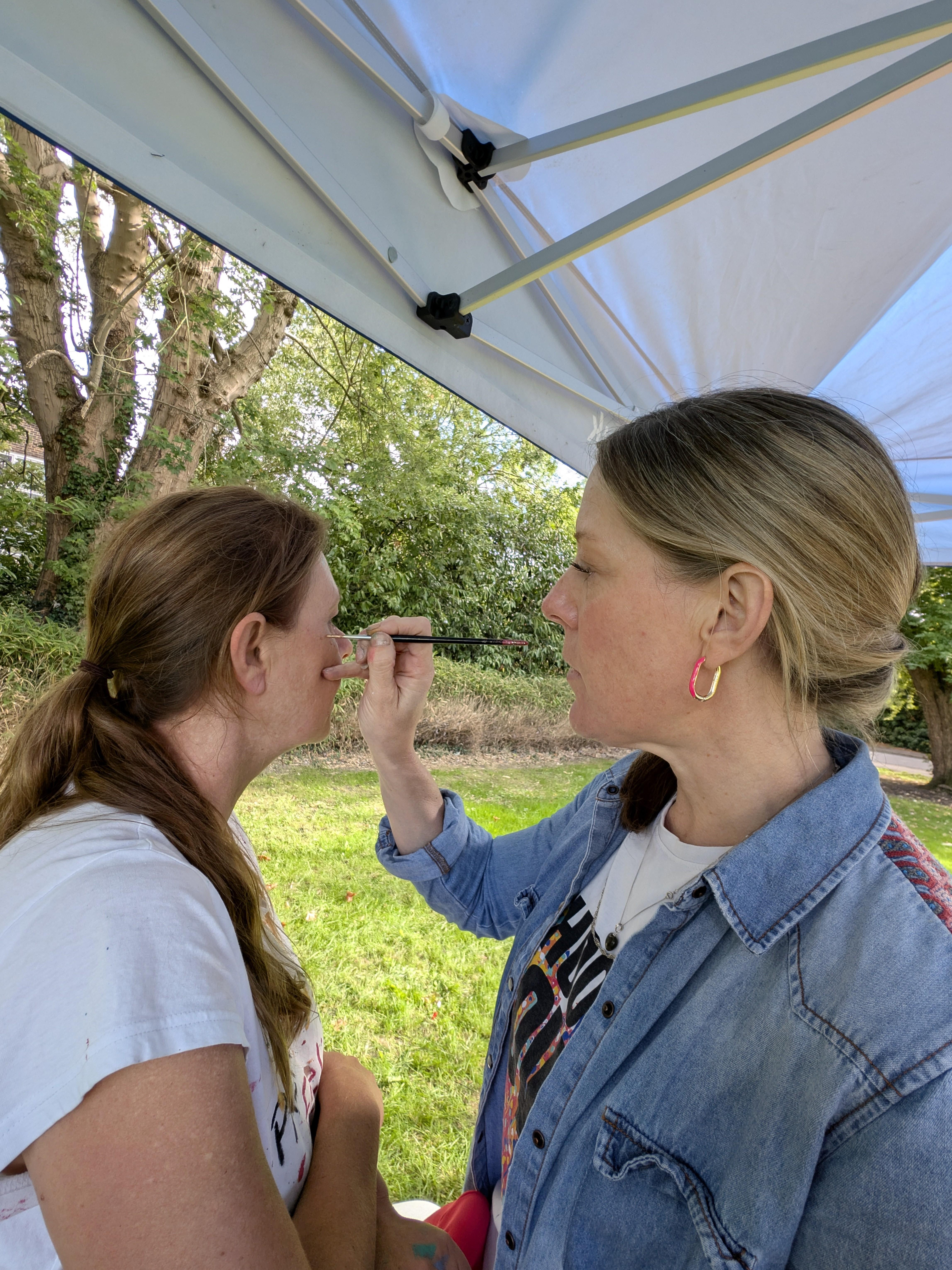 Face painter Liz Young with Janine Tonkin™ during the Wild & Wonder™ community celebration, adding fun and creativity to the event.
