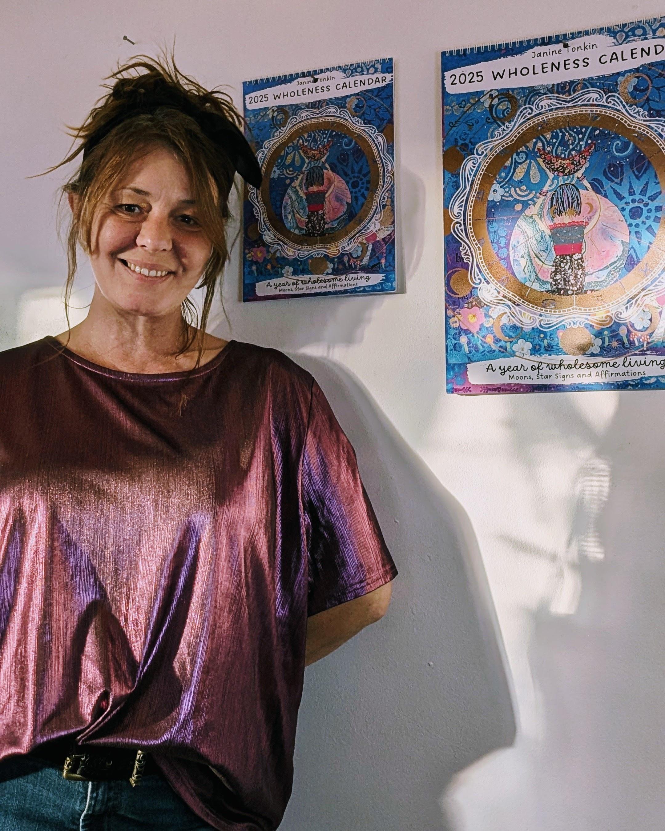 Janine Tonkin™ with her 2025 Wholeness Calendar, featuring original artwork, affirmations, and the creative vision that inspired the Wild & Wonder™ Framework.