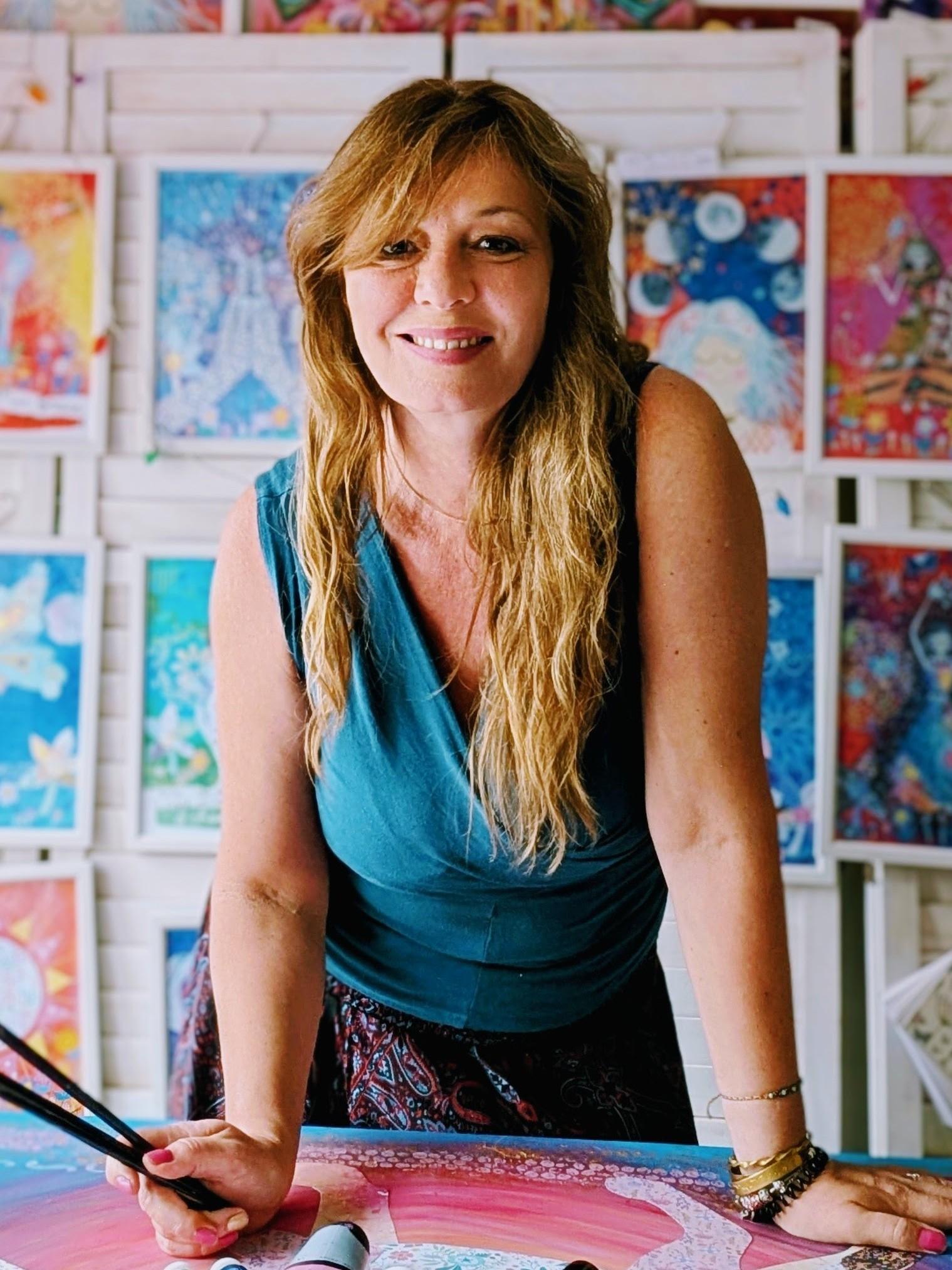 Janine Tonkin™ in her studio surrounded by original art prints while creating a new mixed media artwork, showcasing the creative practice behind the Wild & Wonder™ Framework and the Wild, Wonder & Bloom™  Framework